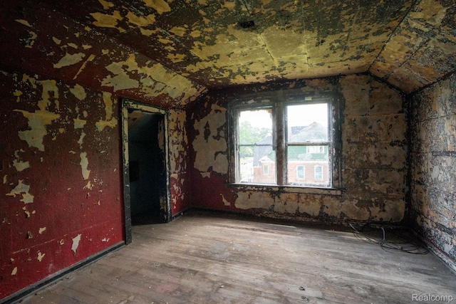 16665 Tuller St, Detroit, MI 48221 - spare room with vaulted ceiling and hardwood / wood-style floors