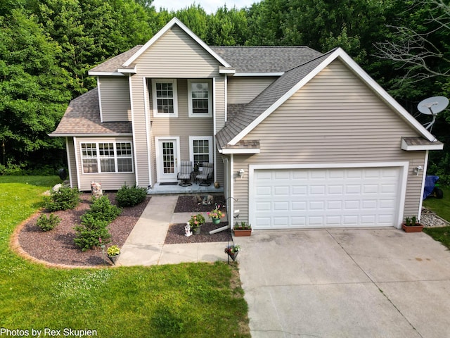 17474 Connor Cir, Bailey, MI 49303 - traditional-style home with a shingled roof, concrete driveway, a front yard, and an attached garage