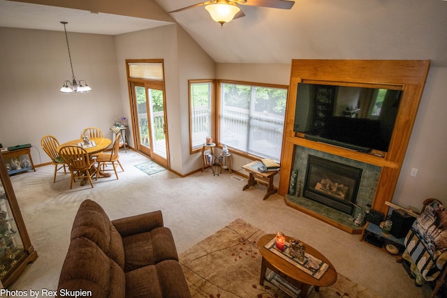 17474 Connor Cir, Bailey, MI 49303 - carpeted living room with lofted ceiling, a ceiling fan, a tile fireplace, and a chandelier