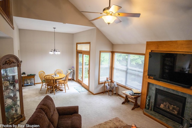 17474 Connor Cir, Bailey, MI 49303 - carpeted living room with a tile fireplace, a ceiling fan, a chandelier, and high vaulted ceiling