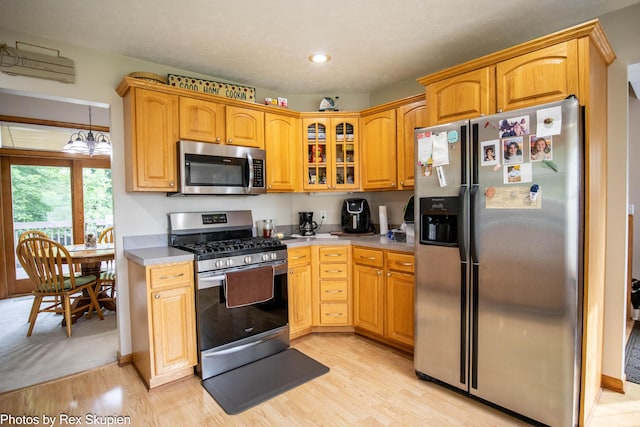 17474 Connor Cir, Bailey, MI 49303 - kitchen featuring stainless steel appliances, glass insert cabinets, light wood-style flooring, recessed lighting, and light countertops