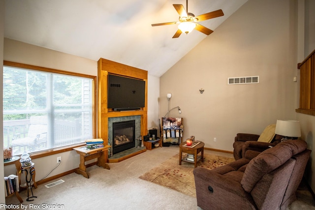17474 Connor Cir, Bailey, MI 49303 - carpeted living room with healthy amount of natural light, a ceiling fan, a tiled fireplace, and lofted ceiling