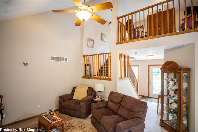 17474 Connor Cir, Bailey, MI 49303 - living area featuring carpet floors, stairway, ceiling fan, and high vaulted ceiling