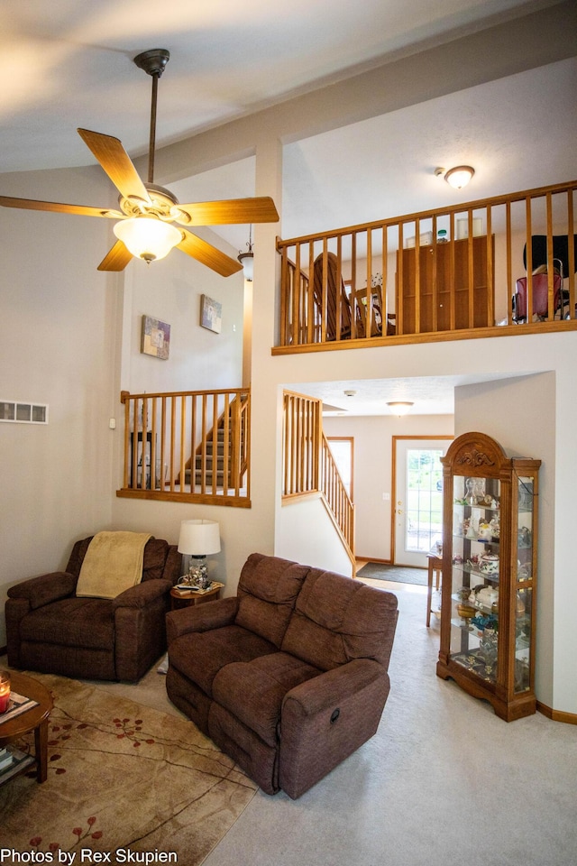 17474 Connor Cir, Bailey, MI 49303 - carpeted living area with a ceiling fan, stairs, and a towering ceiling