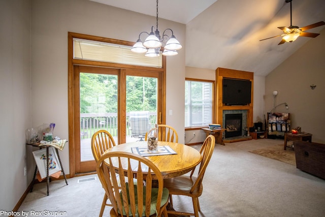 17474 Connor Cir, Bailey, MI 49303 - dining space with light carpet, a fireplace, a chandelier, lofted ceiling, and a ceiling fan