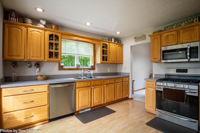 17474 Connor Cir, Bailey, MI 49303 - kitchen with appliances with stainless steel finishes, glass insert cabinets, light wood finished floors, recessed lighting, and brown cabinets