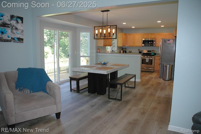 785 Pathway Dr, Howell, MI 48843 - dining space with a chandelier, light wood-type flooring, and recessed lighting