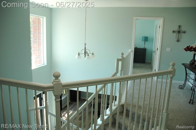 785 Pathway Dr, Howell, MI 48843 - corridor with an upstairs landing, carpet, and a chandelier