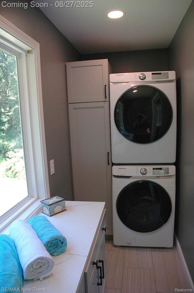 785 Pathway Dr, Howell, MI 48843 - washroom featuring stacked washer / dryer, cabinet space, and recessed lighting