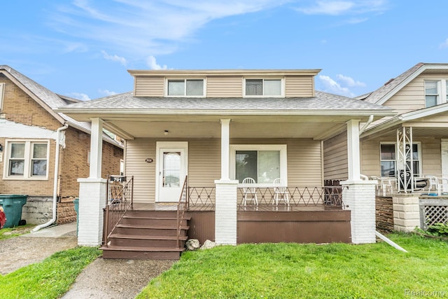 701 Cleophus Pkwy, Lincoln Park, MI 48146 - bungalow-style house with a porch, roof with shingles, and a front lawn