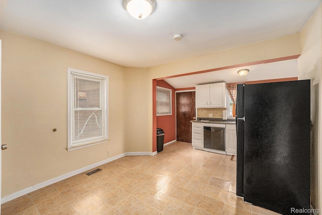 701 Cleophus Pkwy, Lincoln Park, MI 48146 - kitchen featuring freestanding refrigerator, stainless steel dishwasher, white cabinetry, and dark countertops