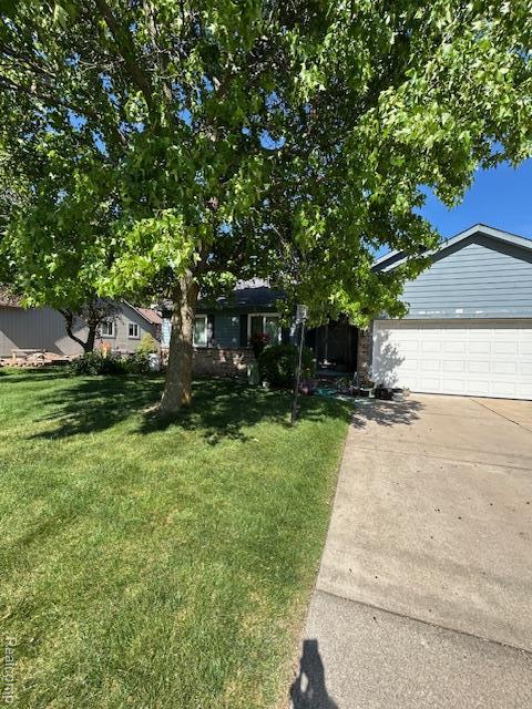20796 Gill Rd, Farmington Hills, MI 48335 - view of property hidden behind natural elements featuring a front yard, driveway, and an attached garage