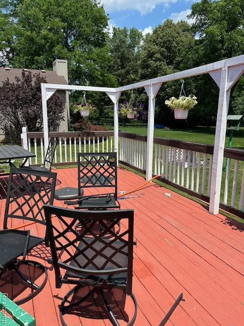 20796 Gill Rd, Farmington Hills, MI 48335 - wooden deck with a water view, outdoor dining space, and view of scattered trees