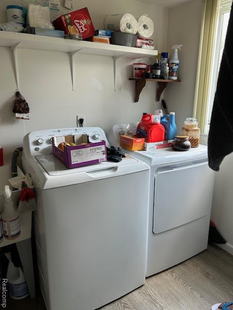 20796 Gill Rd, Farmington Hills, MI 48335 - laundry room with washer and dryer and light wood finished floors