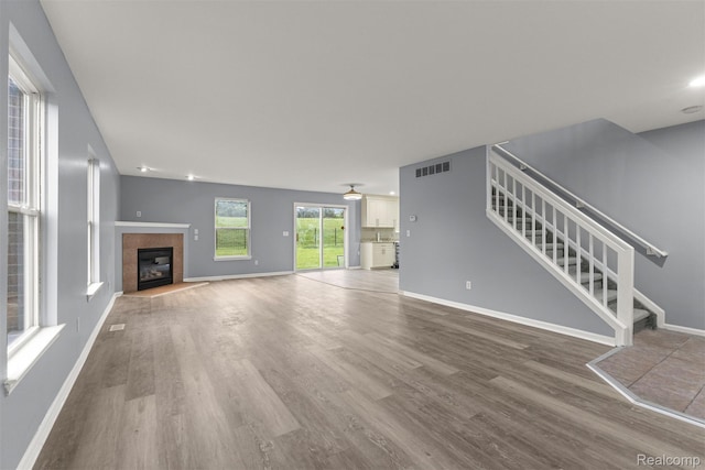 10913 Edlie Cir, Dearborn Heights, MI 48214 - unfurnished living room featuring wood finished floors, stairway, and a fireplace