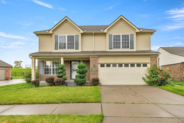 10913 Edlie Cir, Dearborn Heights, MI 48214 - traditional-style house with a front lawn, an attached garage, driveway, brick siding, and a porch