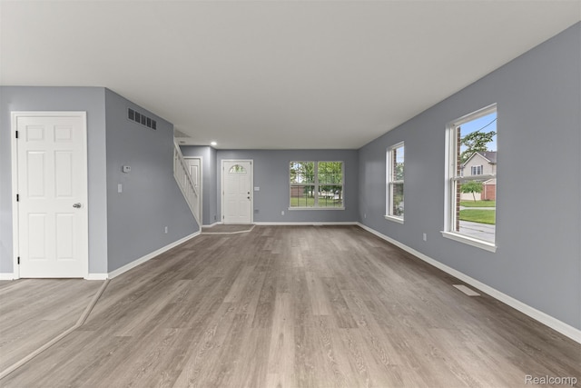 10913 Edlie Cir, Dearborn Heights, MI 48214 - unfurnished living room featuring wood finished floors, stairway, and plenty of natural light