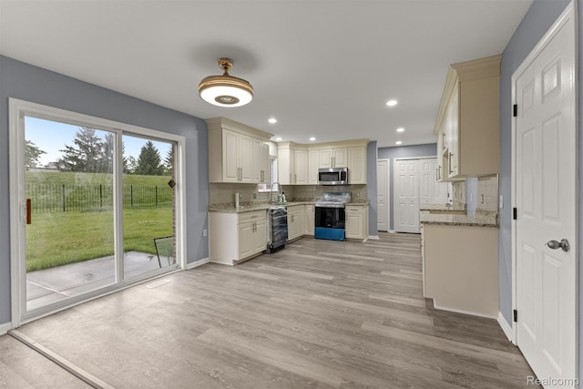 10913 Edlie Cir, Dearborn Heights, MI 48214 - kitchen with appliances with stainless steel finishes, decorative backsplash, light wood-style floors, light stone counters, and recessed lighting