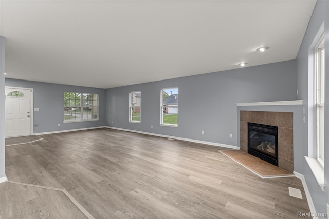 10913 Edlie Cir, Dearborn Heights, MI 48214 - unfurnished living room featuring wood finished floors and a tiled fireplace