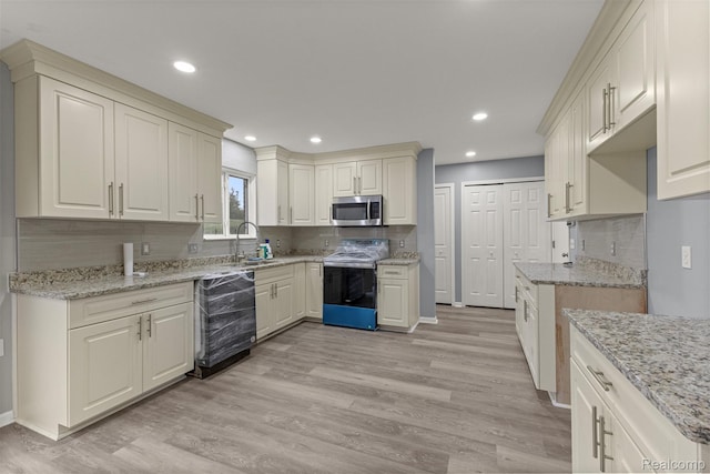 10913 Edlie Cir, Dearborn Heights, MI 48214 - kitchen featuring stainless steel appliances, light wood-type flooring, tasteful backsplash, light stone counters, and recessed lighting