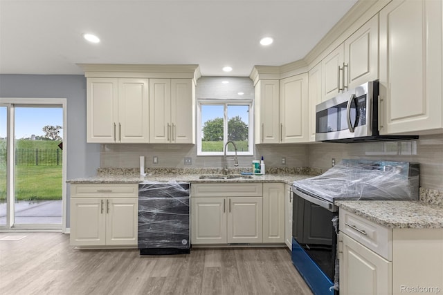 10913 Edlie Cir, Dearborn Heights, MI 48214 - kitchen featuring black electric range, beverage cooler, stainless steel microwave, backsplash, and recessed lighting