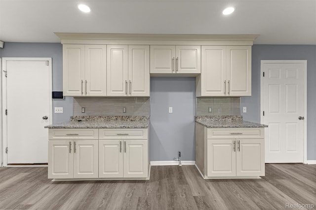 10913 Edlie Cir, Dearborn Heights, MI 48214 - kitchen with decorative backsplash, wood finished floors, light stone countertops, and recessed lighting