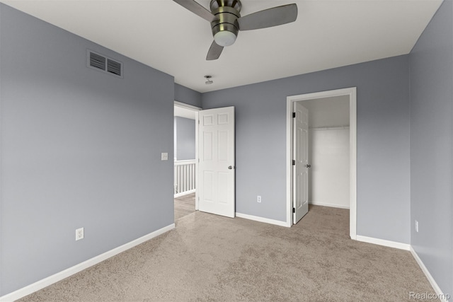 10913 Edlie Cir, Dearborn Heights, MI 48214 - unfurnished bedroom with carpet flooring, a walk in closet, ceiling fan, and a closet