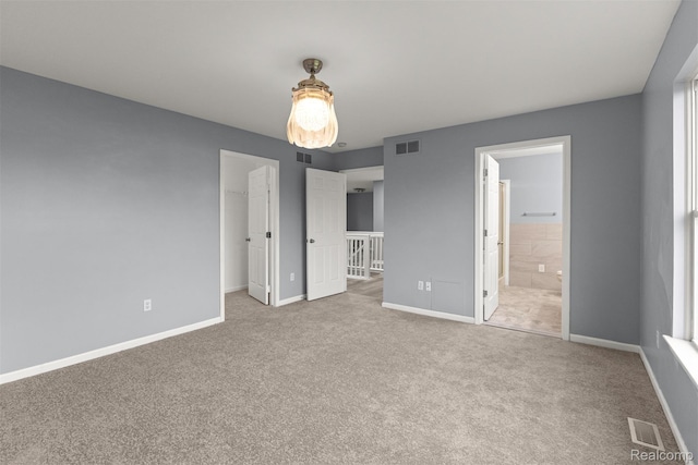10913 Edlie Cir, Dearborn Heights, MI 48214 - unfurnished bedroom with carpet, a spacious closet, connected bathroom, and a closet