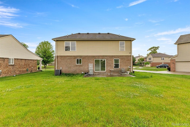 10913 Edlie Cir, Dearborn Heights, MI 48214 - back of property featuring a patio area, a lawn, and brick siding