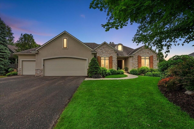 7870 Mooring Ct, Hudsonville, MI 49426 - view of front of house featuring stone siding, stucco siding, asphalt driveway, and an attached garage