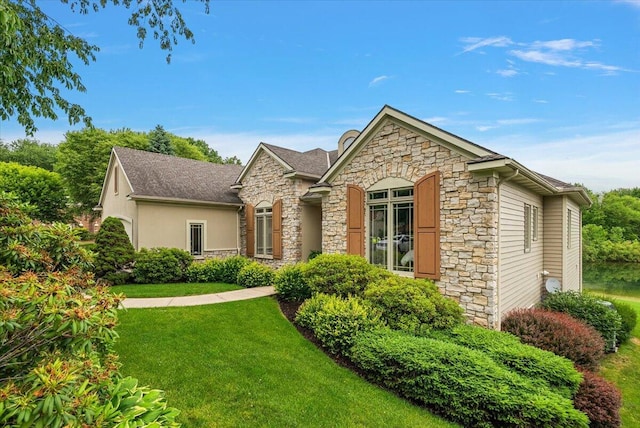 7870 Mooring Ct, Hudsonville, MI 49426 - view of front of home with stone siding and a front yard