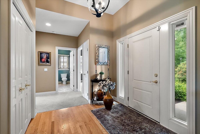7870 Mooring Ct, Hudsonville, MI 49426 - entrance foyer featuring plenty of natural light, light wood finished floors, and a chandelier