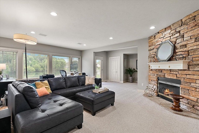 7870 Mooring Ct, Hudsonville, MI 49426 - living area with light carpet, a fireplace, recessed lighting, and a textured ceiling
