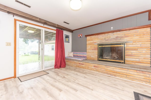 1169 Wilbur, Pinckney, MI 48169 - unfurnished living room featuring wood finished floors, a glass covered fireplace, and crown molding