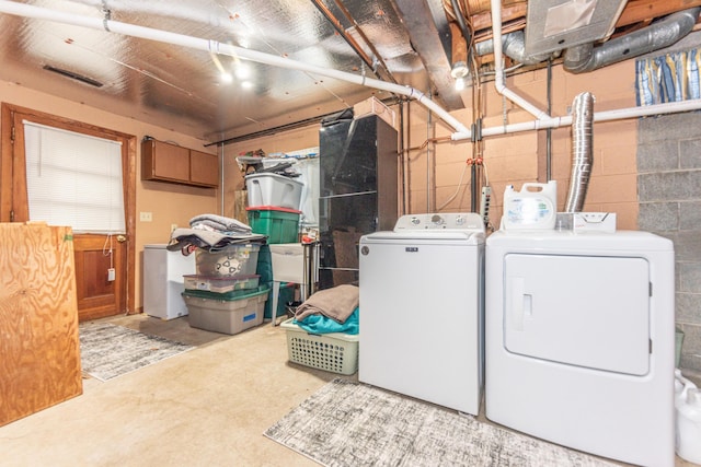1169 Wilbur, Pinckney, MI 48169 - washroom with washing machine and clothes dryer and concrete block wall