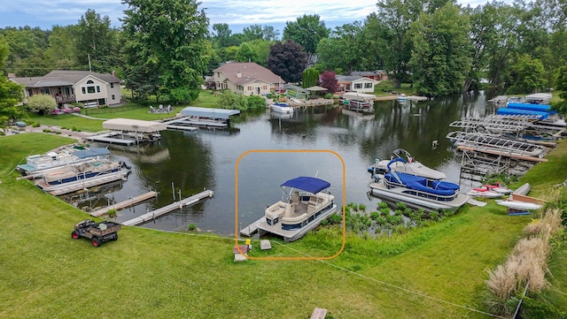 1169 Wilbur, Pinckney, MI 48169 - dock area featuring a water view and a lawn