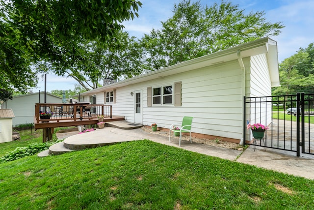 1169 Wilbur, Pinckney, MI 48169 - back of house with a deck, a patio area, and a gate