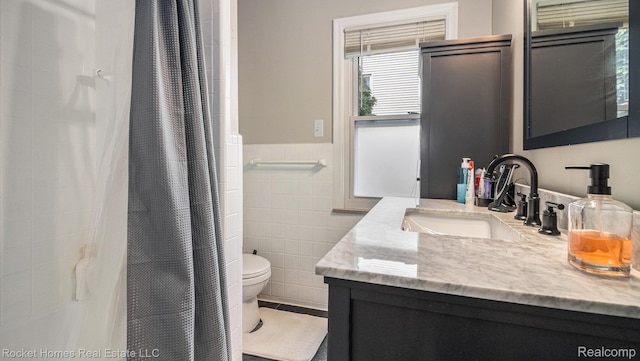 22011 Englehardt St, Saint Clair Shores, MI 48080 - full bath with tile walls, vanity, curtained shower, and a wainscoted wall
