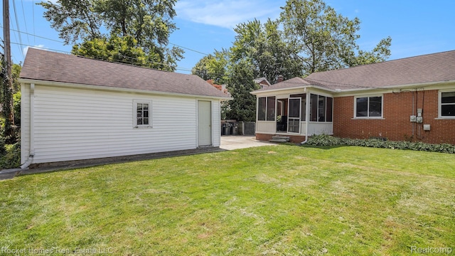 22011 Englehardt St, Saint Clair Shores, MI 48080 - view of grassy yard featuring a sunroom and a patio area