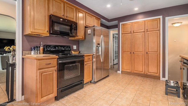 22011 Englehardt St, Saint Clair Shores, MI 48080 - kitchen with black appliances, light countertops, light tile patterned floors, arched walkways, and recessed lighting