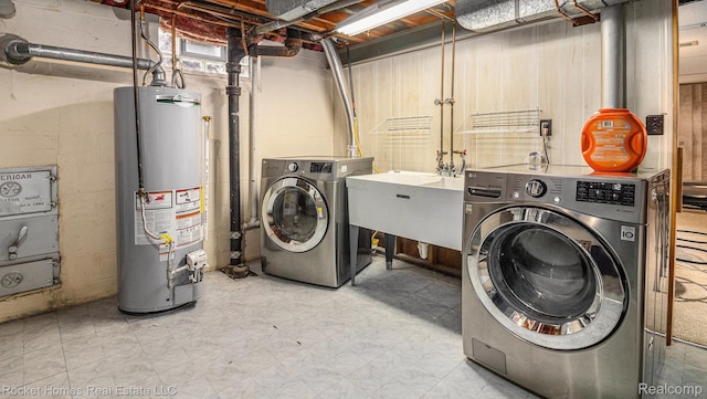 22011 Englehardt St, Saint Clair Shores, MI 48080 - laundry room with gas water heater, washer and dryer, and tile patterned floors