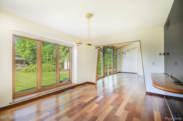 3234 Pine Lake Rd, West Bloomfield, MI 48324 - unfurnished dining area featuring healthy amount of natural light, wood finished floors, and a chandelier