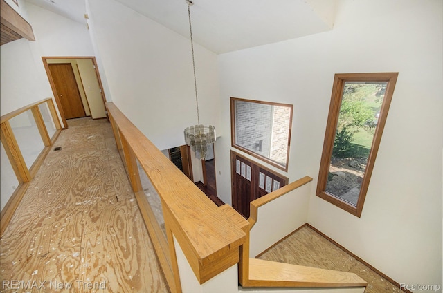 3234 Pine Lake Rd, West Bloomfield, MI 48324 - stairs with a chandelier and high vaulted ceiling