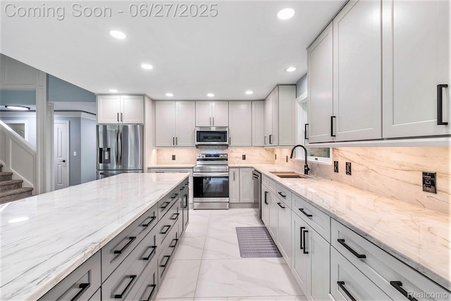 5408 N Seymour Rd, Flushing, MI 48433 - kitchen with stainless steel appliances, gray cabinetry, light stone counters, light marble finish flooring, and backsplash