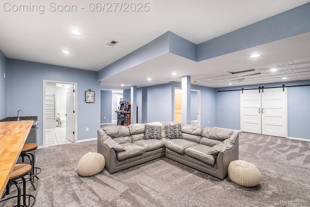5408 N Seymour Rd, Flushing, MI 48433 - living area featuring carpet flooring, a barn door, and recessed lighting