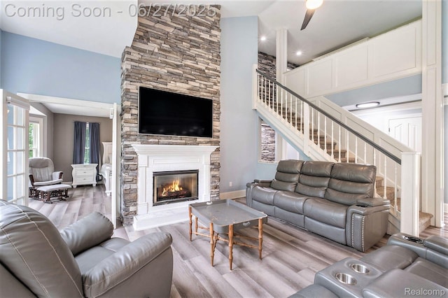 5408 N Seymour Rd, Flushing, MI 48433 - living area featuring stairway, wood finished floors, a fireplace, and a high ceiling