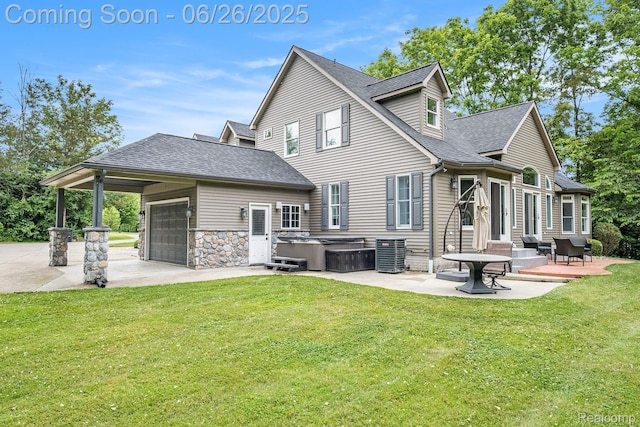 5408 N Seymour Rd, Flushing, MI 48433 - rear view of house with a hot tub, a lawn, concrete driveway, a patio area, and an attached garage