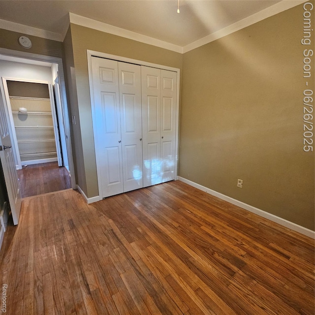 30146 Boewe Dr, Warren, MI 48092 - unfurnished bedroom with crown molding, hardwood / wood-style flooring, and a closet