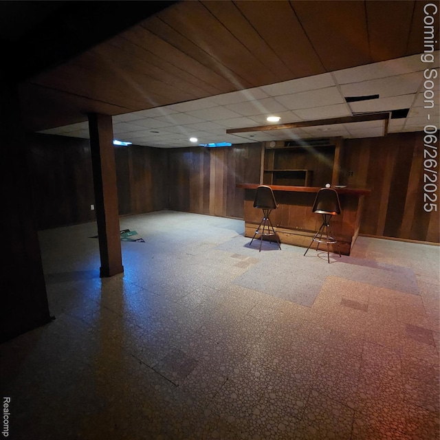 30146 Boewe Dr, Warren, MI 48092 - finished below grade area featuring tile patterned floors, wooden walls, a paneled ceiling, and bar area
