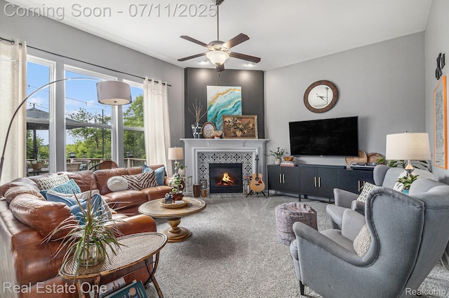 59141 Peters Barn Dr, South Lyon, MI 48178 - carpeted living area with a ceiling fan and a tiled fireplace